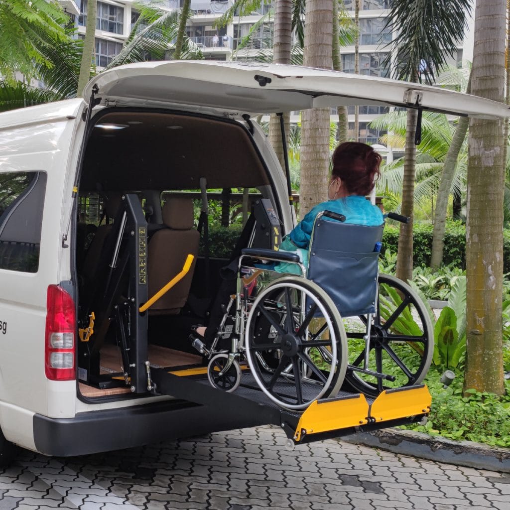 wheelchair transport with wheelchair user on hydraulic lift
